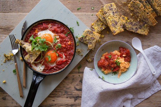 Madeleine's Shakshuka With Homemade Cornbread on a table