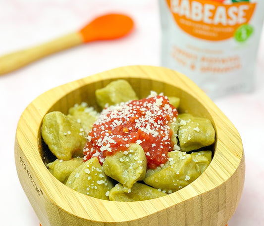 A bowl of baby gnocchi next to a Babease pouch