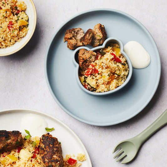 Mini lamb koftas served with roasted veg Cous Cous on a weaning plate with a dollop of Greek yoghurt