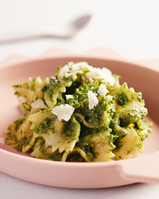 A plate of green sauce pasta.