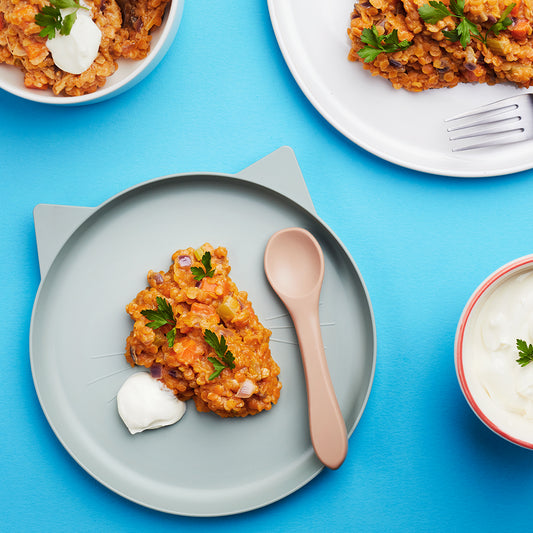 Lentil vegetable curry weaning recipe served on pale blue weaning plate with a dollop of yoghurt 