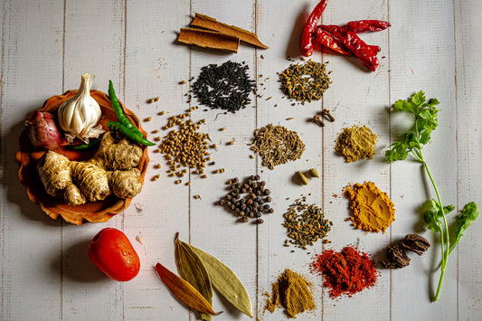 An assortment of herbs and spices on a wooden board